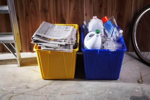 Recycling bins and separated materials at a garden clearance site